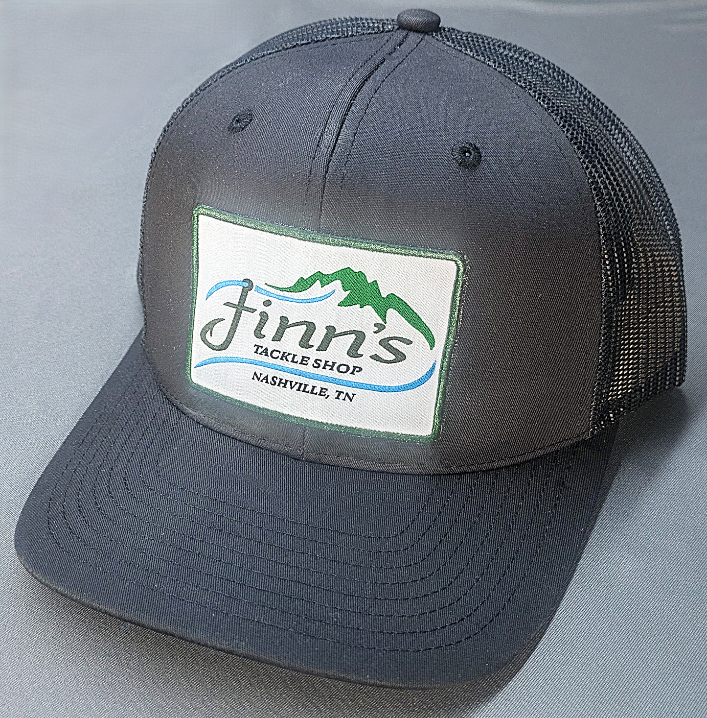 It’s black in color for those who spend their nights on the water and then wake up next to a campsite that lingers with the smell of fish and bad decisions.&nbsp; This hat will impress absolutely no one except the other person still sleeping next to you.&nbsp; Let everyone know that the only thing classy about you is where you shop for your tackle.&nbsp; Finn’s Tackle Shop.
